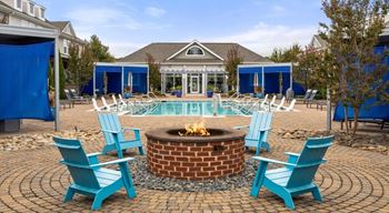 Poolside fire pit with lounge chairs